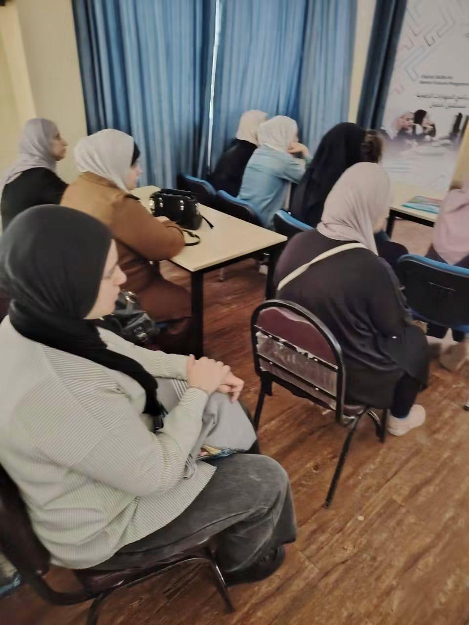 Women seated at tables during a community workshop